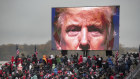 Fighting back. Supporters of President Donald Trump watch a video during a campaign event in Michigan.