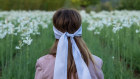 A blindfolded guest at Matiere Premiere’s tuberose harvest seated in front of a plot of bright white blooms. 