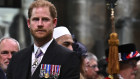 Prince Harry leaves Westminster Abbey after the coronation.