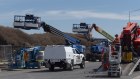 Rush job: Subcontractors and suppliers hastened to remove equipment from Roberts Co’s Amazon warehouse site in Melbourne’s Craigieburn on Friday, hours before the company went into administration. 