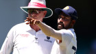 Mohammed Siraj of India stops play to make a formal complaint to Umpire Paul Reiffel about some spectators in the bay behind his fielding position.