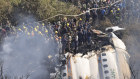 Rescue workers gather around the crashed plane.
