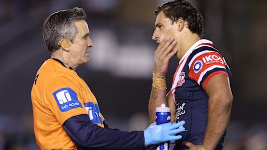 Billy Smith grabs at his fractured jaw.