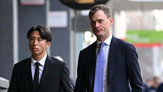 Western United player Riku Danzaki (left) arrives at Melbourne Magistrates’ Court to face allegations of deliberately receiving yellow cards in a match.
