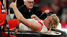 William Edwards is taken from the ground with a broken leg.