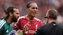 Alisson Becker and Virgil van Dijk of Liverpool appeal to referee Samuel Barrott.