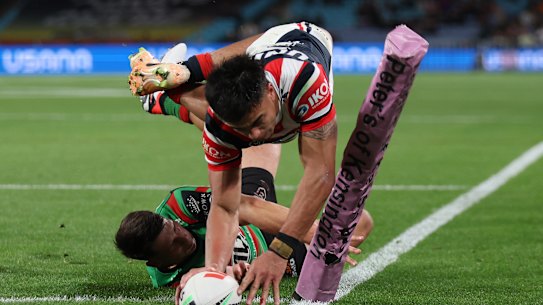 Junior Pauga dives across in the corner to put the Roosters ahead at half-time.