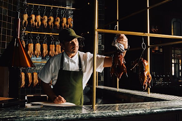 Louis Tikaraminspecting the Peking ducks at Stanley in Manly.