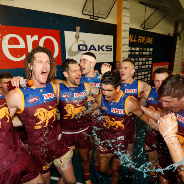 Hodge, third from the left, celebrates with teammates during a round nine match against the Hawks in 2018.  