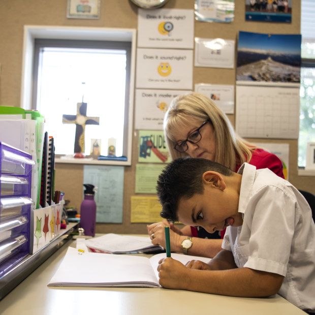 Elias Dahrie, 6, reads using a whole-language method with teacher Maree Grainger.