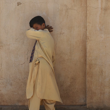 A boy walks along a wall at Zero Point.
