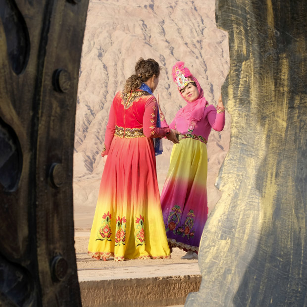 Women in Uighur costumes at the Flaming Mountains in Turpan, Xinjiang, last month.
