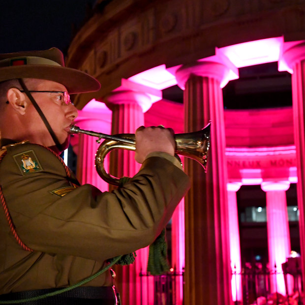 An army bugler is seen playing the last post during the Anzac Day dawn service at  the Shrine of Remembrance in Anzac Square in Brisbane, Thursday, April 25, 2019. 