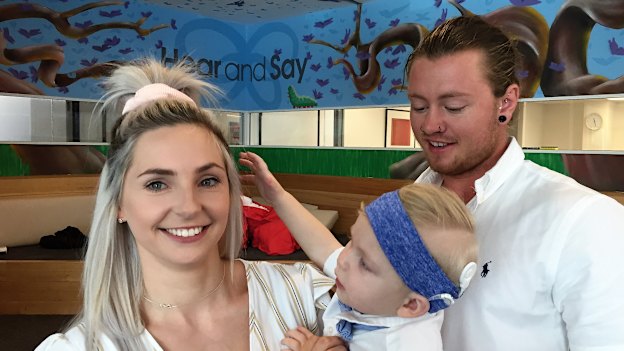 Rome Whelan, 18 months, is seen with his mother Renae Whelan and father Ryan Walker, celebrating his new cochlear implant.