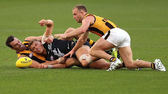 Jon Ceglar and Tom Mitchell teamed up to tackle Patrick Cripps at Optus Stadium last Friday.