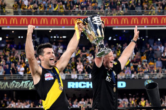 Trent Cotchin and Damien Hardwick lift the 2020 premiership cup after last year’s grand final at the Gabba.