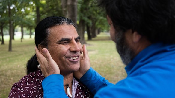 Afghan refugee from Australia , Abdul Aziz, 48, is hugged by a complete stranger saying, "You are a hero , you saved our lives."