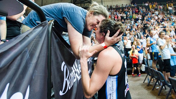 Kelsey Griffin kisses her wife Erin after winning the grand final.