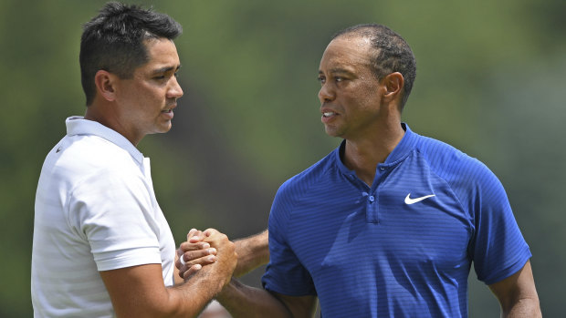 Emotional day: Woods and Day shake hands after the first round of the Bridgestone Invitational.