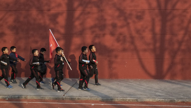 Backbone of the Chinese people: The Real Boys Club walk to their bus at the end of training.