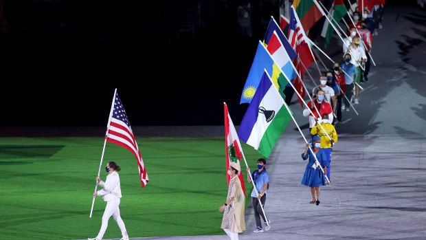 More flagbearers enter the closing ceremony. 