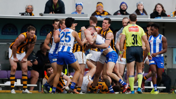 Hawthorn and North Melbourne players wrestle during their round 19 clash.