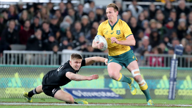 In the clear: Dane Haylett-Petty runs past All Blacks centre jack Goodhue during Australia's 40-12 loss at Eden Park. 