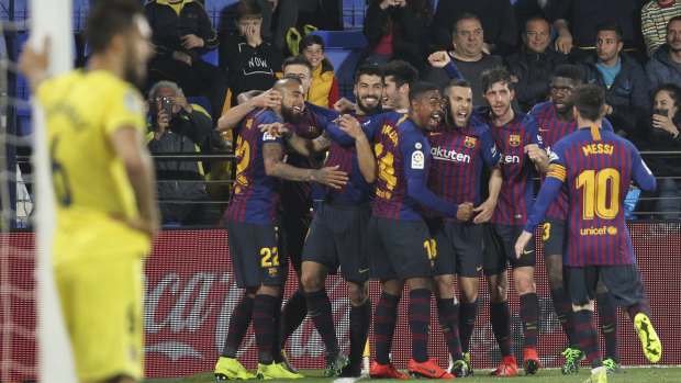 Luis Suarez is swamped by his Barca teammates after scoring the equaliser in added time.