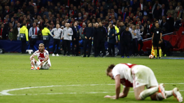 Down and out: Ajax's Hakim Ziyech and Ajax's Frenkie de Jong, right, in front of a stunned crowd after Tottenham scored their third goal.