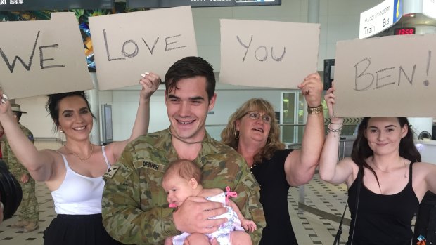 Jenna, Ruby, Janell and Emily were waiting for Private Benjamin Driver at Brisbane Airport on Thursday afternoon. 