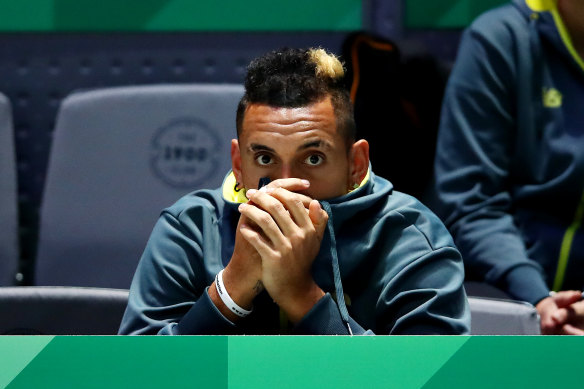 Nick Kyrgios watches on, unable to play because of a collarbone problem.