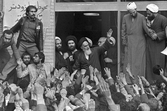 The Ayatollah Ruhollah Khomeini waves to followers from the balcony of his headquarters in Tehran in 1979.