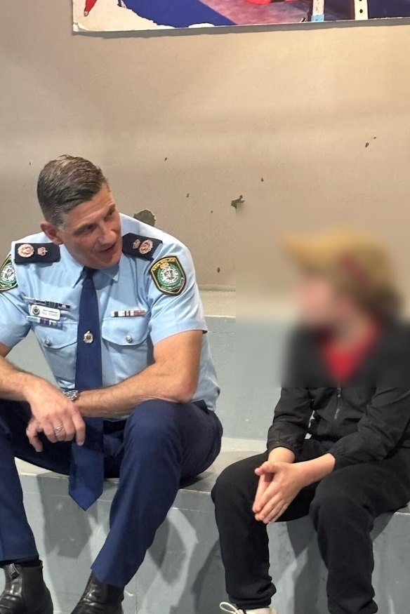 Deputy Commissioner Paul Pisanos talks to a child in Dubbo.