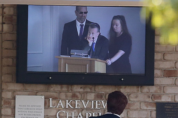 The father of slain Brisbane teenager Larissa Beilby, Peter (left), and sister Deanna (right) can be seen on a TV screen outside Lakeview Chapel during the memorial service.