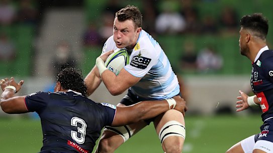 Jack Dempsey of the Waratahs gets muscled by the Rebels defence.