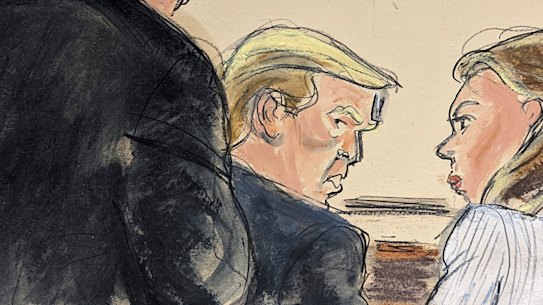 Trump advisor Boris Epshteyn, foreground left, leans over Donald Trump to confer with him and lead defence attorney Alina Habba, right, prior to jury selection in Federal Court, in New York.