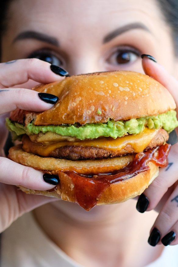 Brekkie burger with vegan sausage, fried egg, potato cake and more.