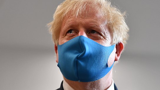 Prime Minister Boris Johnson wears a face mask during a visit to an ambulance station on Monday.