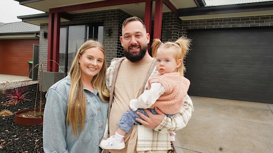 Tim and Loren Horster-Haarburger with daughter Ivy at the Cobblebank home they sold in two weeks.