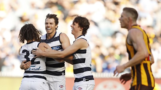 MELBOURNE, AUSTRALIA - APRIL 05: Gryan Miers of the Cats celebrates a goal with Isaac Smith and Max Holmes during the 2021 AFL Round 03 match between the Geelong Cats and the Hawthorn Hawks at the Melbourne Cricket Ground on April 05, 2021 in Melbourne, Australia. (Photo by Dylan Burns/AFL Photos via Getty Images)