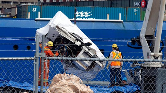 Debris from the Titan submersible, recovered from the ocean floor near the wreck of the Titanic, is unloaded from the ship Horizon Arctic at the Canadian Coast Guard pier in St. John’s, Newfoundland.