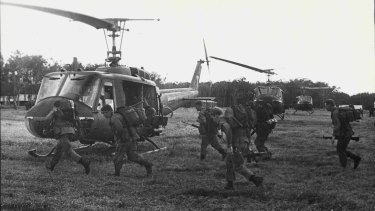 Troops of the 3rd Battalion, Royal Australian Regiment, run to board helicopters on the flyout from Kapyong Pad.