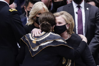 Alma Powell hugs former secretary of state Hillary Clinton after the funeral service. 