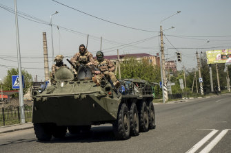 Ukrainian troops ride on top of an armoured personnel carrier in Kramatorsk, in the Donbas region of Ukraine.