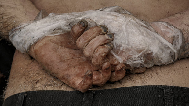 A lifeless body of a man with his hands tied behind his back lies on the ground in Bucha, Ukraine, on Sunday.