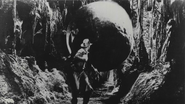 Indiana Jones (Harrison Ford) runs for his life as a huge boulder threatens to crush him in Raiders of The Lost Ark. 