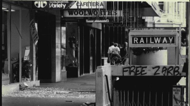 Shattered glass covers the street after a bomb blast at Woolworths, Town Hall, December 24, 1980. 
