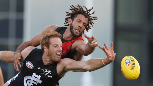 Essendon's Zac Clarke vies with Carlton's Andrew Phillips in a pre-season game this year.
