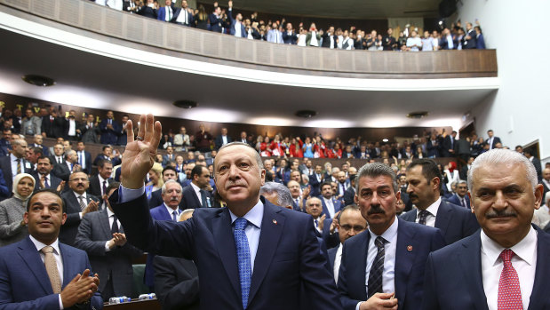 Turkish President Recep Tayyip Erdogan, centre, arrives to deliver a speech last week. 