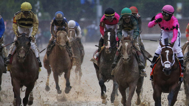 Mud and guts: Maximum Security, right, is first past the post in the Kentucky Derby ahead of Country House, left.